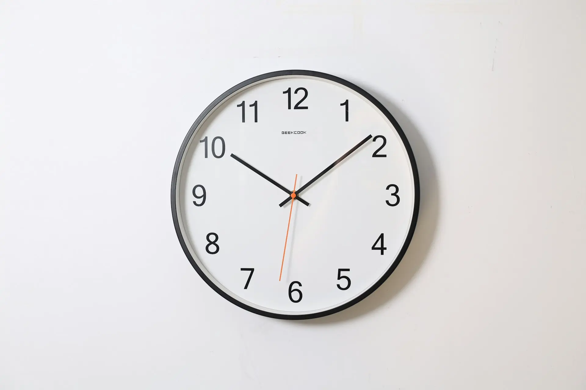 round analog wall clock pointing at 10:09